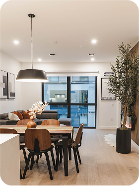 Dining room with glass table and beige chairs
